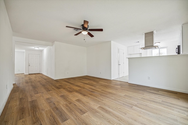 unfurnished living room with light hardwood / wood-style flooring and ceiling fan