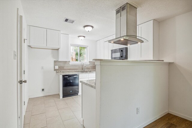 kitchen featuring a textured ceiling, black appliances, white cabinets, and island exhaust hood