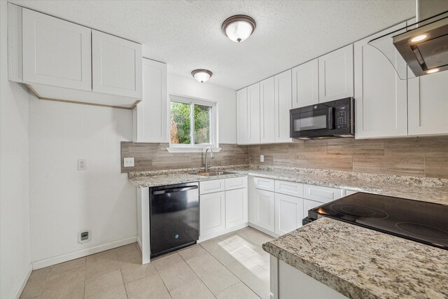 kitchen featuring black appliances, backsplash, sink, light stone counters, and white cabinets