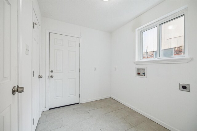 washroom featuring hookup for a washing machine, light tile patterned flooring, and hookup for an electric dryer