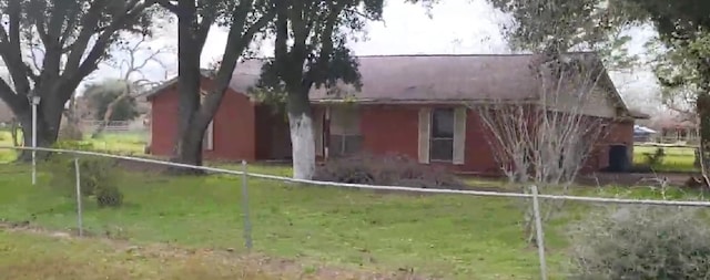 view of side of home with a yard