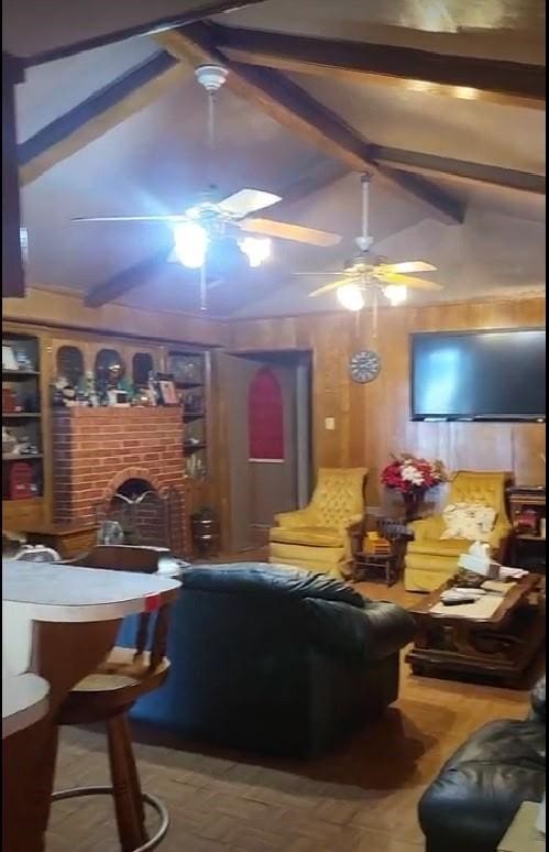 bar with ceiling fan, vaulted ceiling with beams, and a brick fireplace