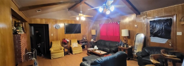 living room featuring hardwood / wood-style floors, wood walls, ceiling fan, and vaulted ceiling with beams