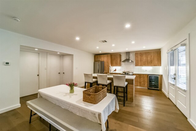 interior space featuring beverage cooler and hardwood / wood-style floors