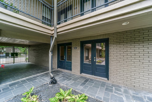 entrance to property with a balcony and french doors