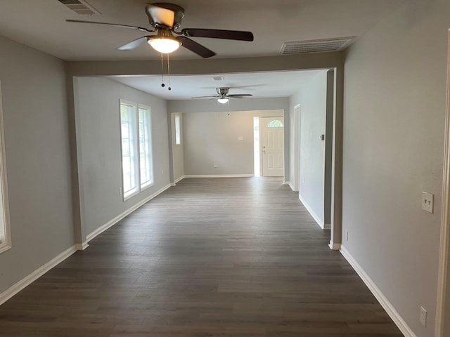 unfurnished room featuring ceiling fan and dark hardwood / wood-style flooring