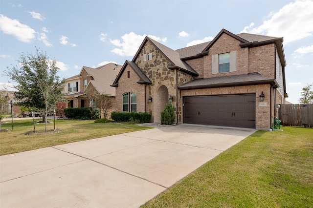 view of front of home with a front yard and a garage