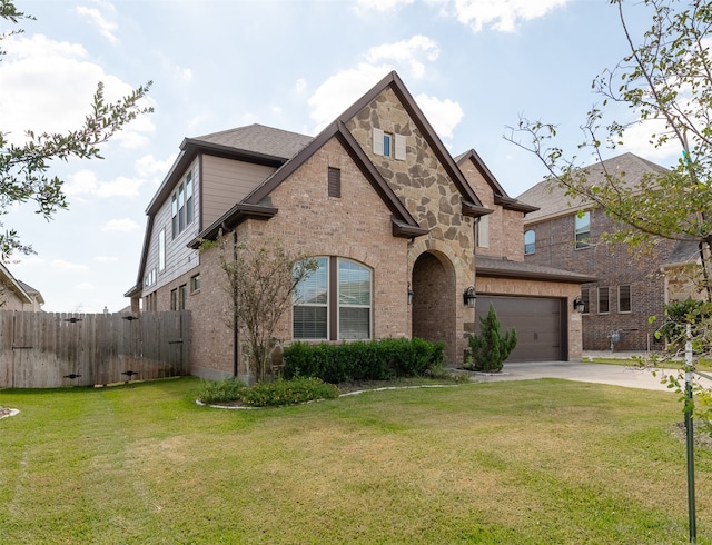 view of front of home with a front yard and a garage