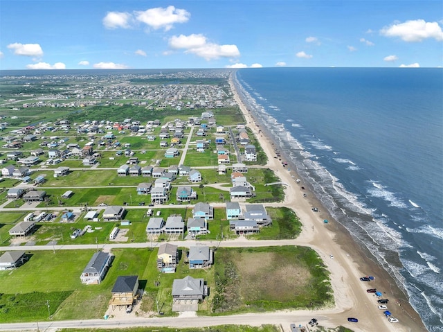 birds eye view of property featuring a beach view and a water view