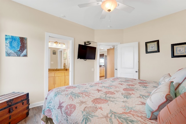 bedroom with ensuite bathroom, sink, ceiling fan, and wood-type flooring