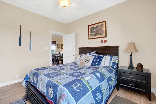 bedroom featuring hardwood / wood-style flooring and ceiling fan