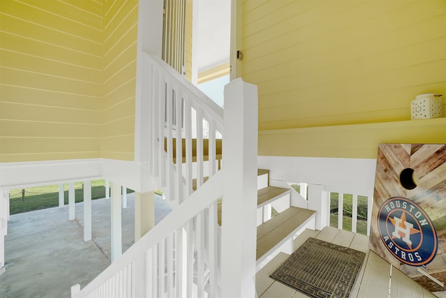 stairs with a wealth of natural light and wood walls