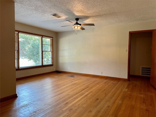 empty room featuring light hardwood / wood-style flooring, a textured ceiling, and ceiling fan