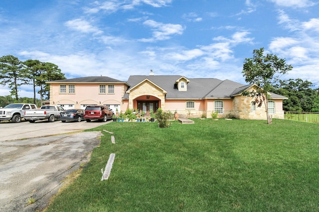 10510 Crosby Lynchburg Rd, Crosby, TX 77532 - view of front of house with stone siding, french doors, driveway, a chimney, and stucco siding