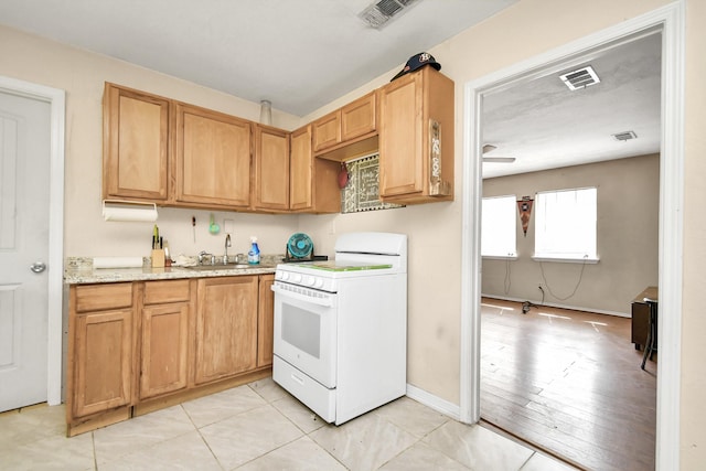 10510 Crosby Lynchburg Rd, Crosby, TX 77532 - kitchen featuring white electric stove, a sink, light stone countertops, and baseboards