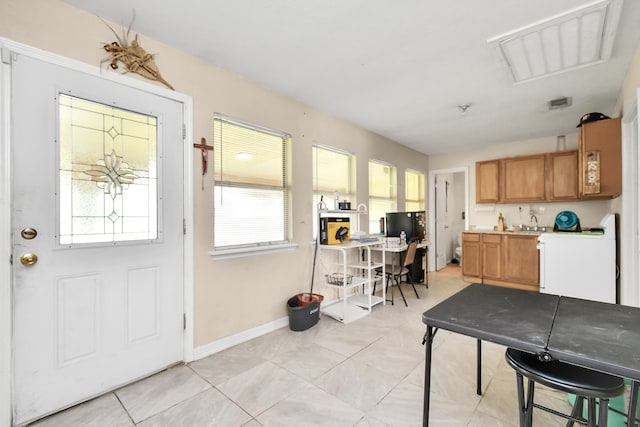 entrance foyer featuring sink and light tile patterned floors