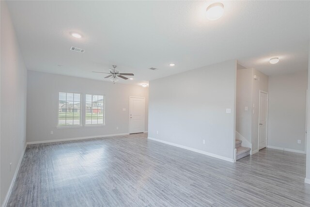 spare room with ceiling fan and light hardwood / wood-style floors