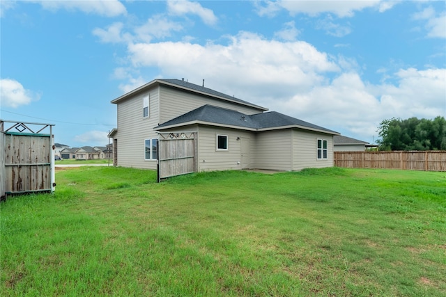 back of house featuring a yard