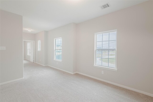 empty room with light colored carpet