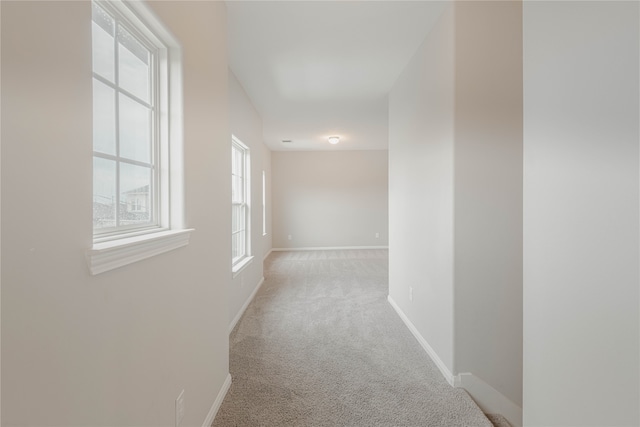 corridor with light colored carpet