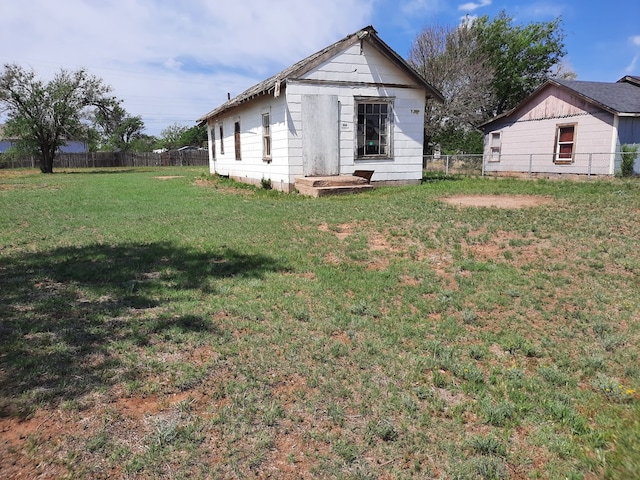 back of property with a yard