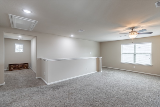 empty room with ceiling fan and carpet floors