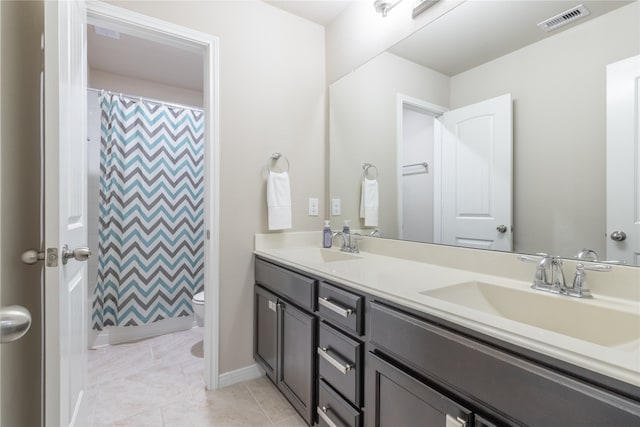 bathroom with tile patterned flooring, a shower with curtain, toilet, and vanity