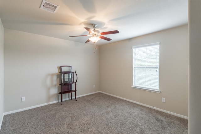 unfurnished room featuring ceiling fan and carpet floors