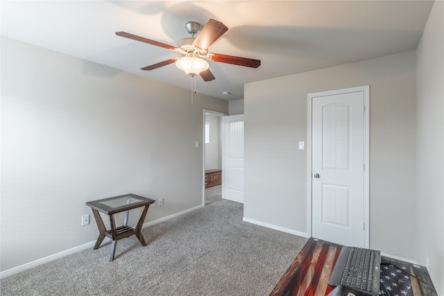 carpeted empty room featuring ceiling fan