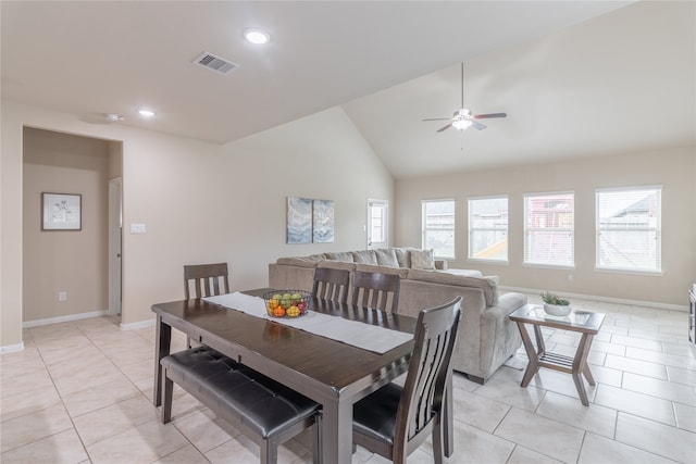 dining room featuring lofted ceiling, ceiling fan, and light tile patterned floors