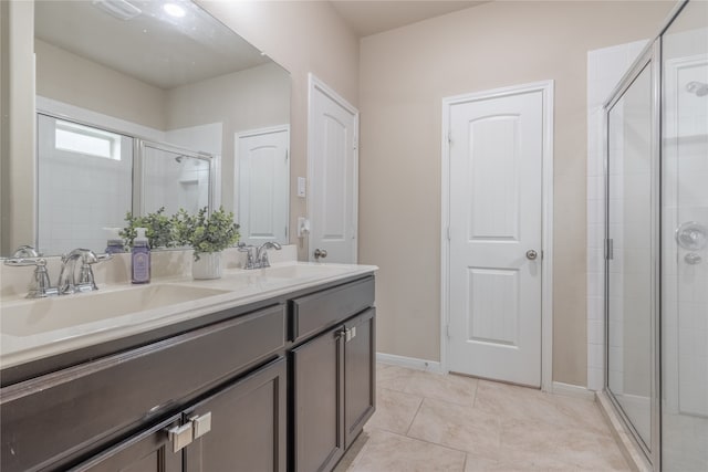 bathroom with tile patterned flooring, vanity, and an enclosed shower