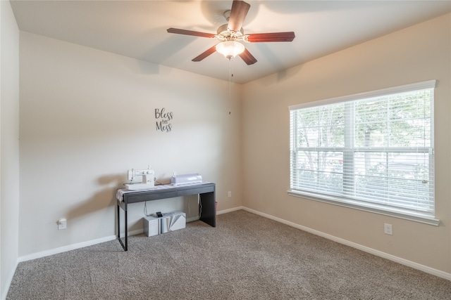 carpeted office space with a healthy amount of sunlight and ceiling fan