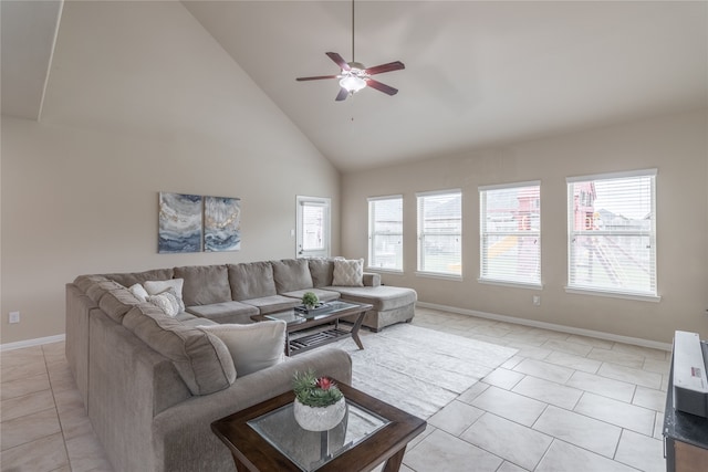 tiled living room with ceiling fan and high vaulted ceiling