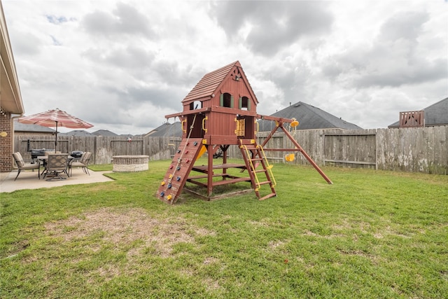 view of jungle gym with a lawn and a patio