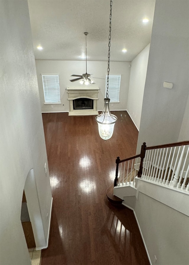 interior space with ceiling fan, hardwood / wood-style flooring, and a textured ceiling