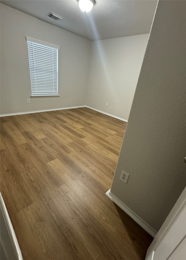 spare room with hardwood / wood-style flooring