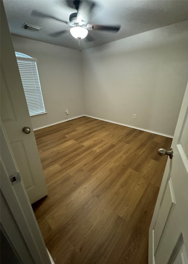 spare room featuring hardwood / wood-style flooring and ceiling fan