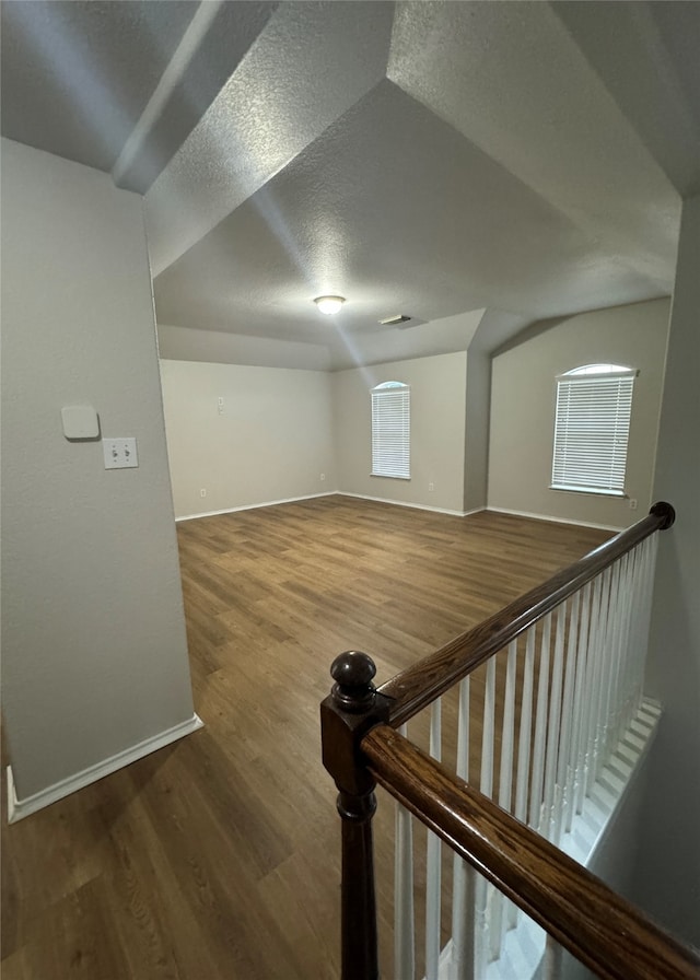 bonus room featuring a textured ceiling and wood-type flooring