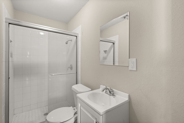 bathroom featuring vanity, toilet, and an enclosed shower