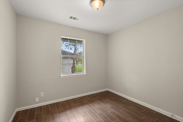 empty room featuring dark hardwood / wood-style flooring