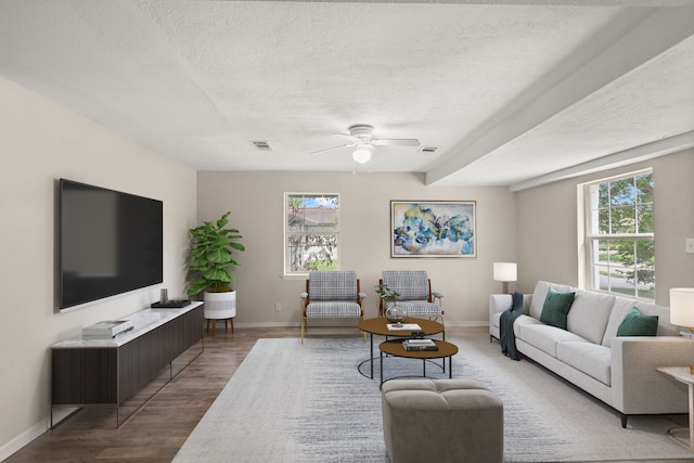 living room with hardwood / wood-style flooring, a textured ceiling, plenty of natural light, and ceiling fan