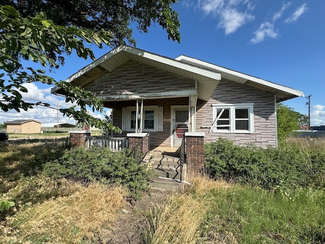 rear view of house featuring a porch