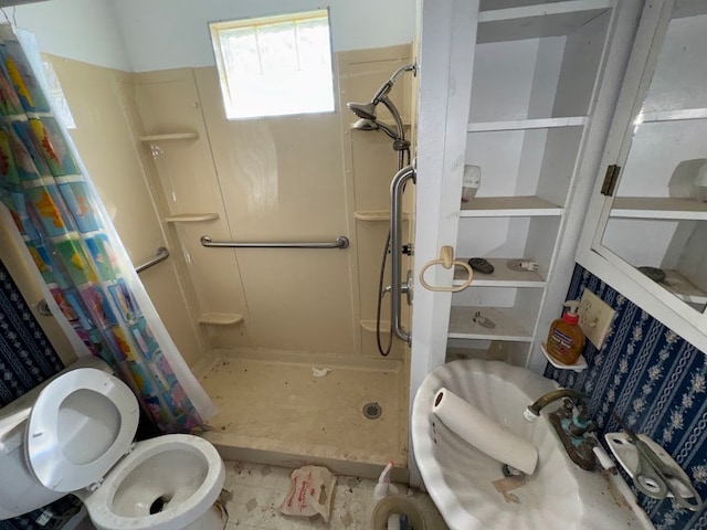 bathroom featuring toilet and a shower with curtain