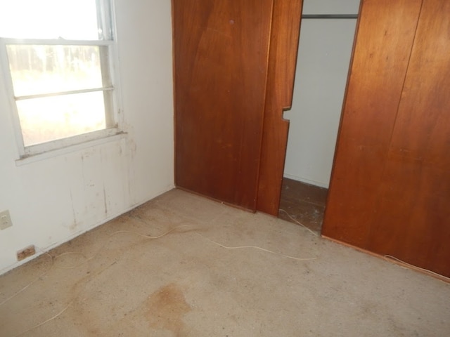 unfurnished bedroom featuring multiple windows