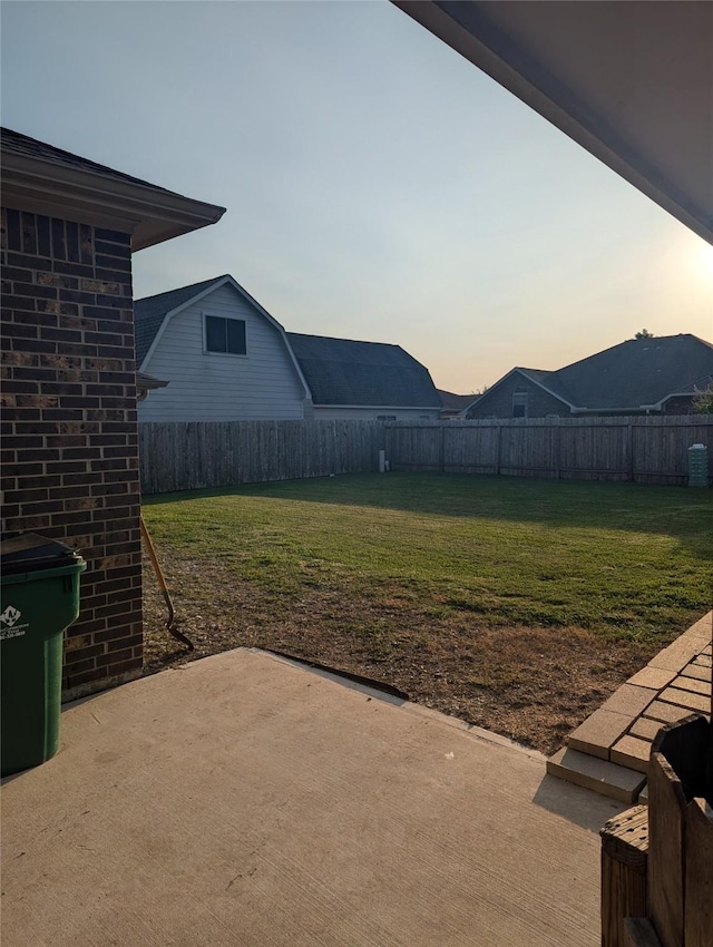 yard at dusk with a patio area