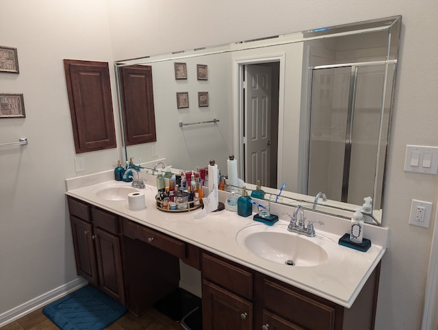 bathroom featuring vanity and a shower with door