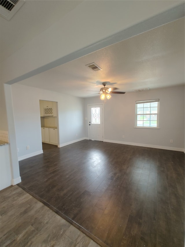 spare room featuring ceiling fan and dark hardwood / wood-style flooring