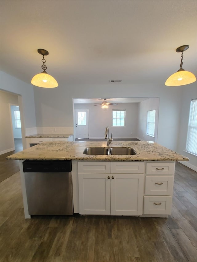 kitchen featuring dark wood finished floors, visible vents, light stone counters, dishwasher, and a sink