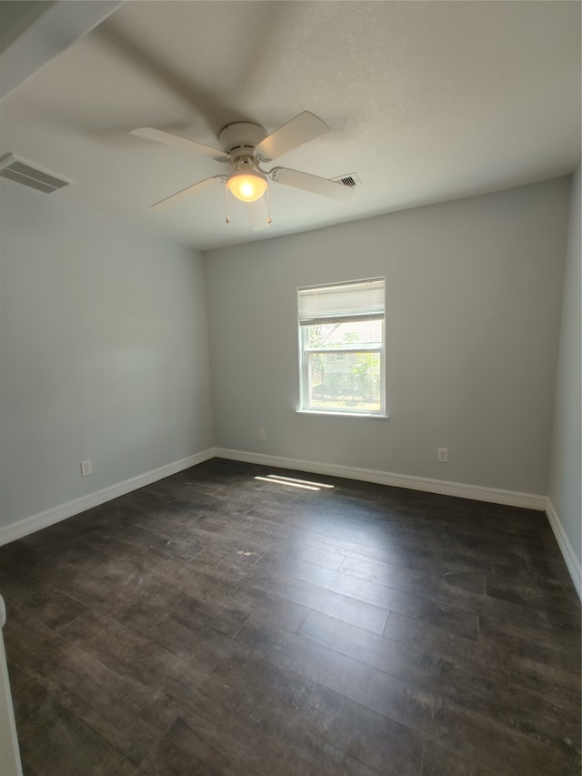 spare room with ceiling fan and dark hardwood / wood-style flooring