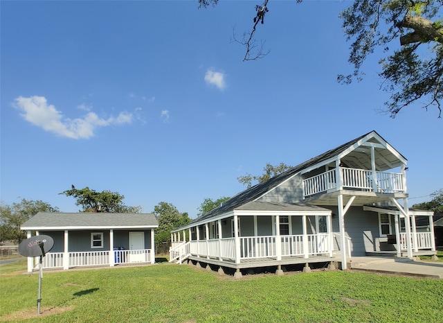 view of front of home with a front lawn and a balcony